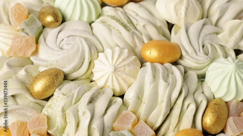 Handmade marshmallows, zephyr and glazed nuts, rotation, closeup