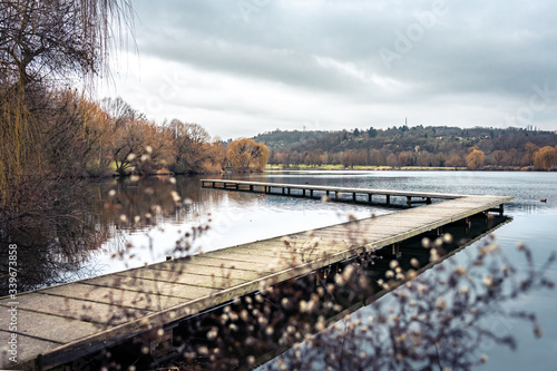Hidden view of a beautiful wooden jetty at a quiet lake where the clouds are reflected  Stuttgart, Max-Eyth-See © Doris