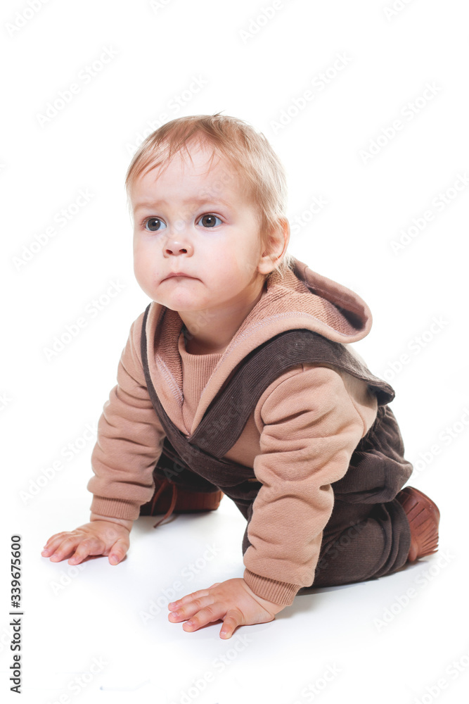 portrait of a charming one-year-old little boy on a white background, dressed in brown trousers, a beige hoodie, portrait of a charming one-year-old little boy on a white background, dressed in brown trousers, a beige hoodie,