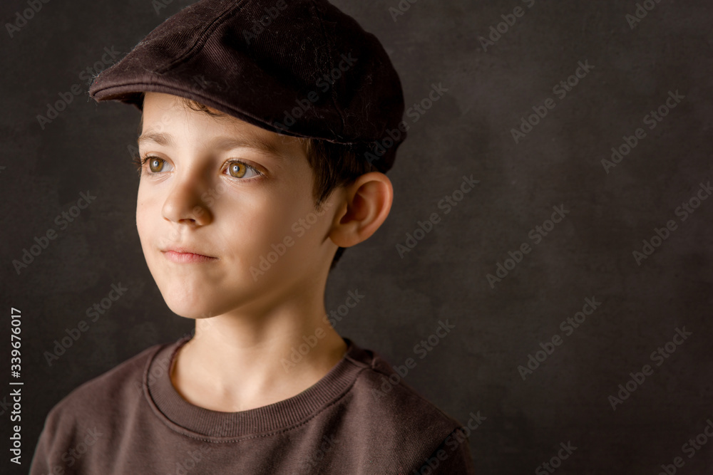 smiling kid looking at camera with a brown vintage cap smiling kid looking at camera with a brown vintage cap