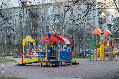 Children playground closed and blocked with a barrier tape due to the corona virus covid19. It is forbidden to be on the playground. 