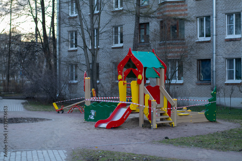 Children playground closed and blocked with a barrier tape due to the corona virus covid19. It is forbidden to be on the playground.