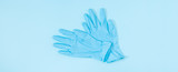 Blue medical gloves on light blue background.Minimal medical concept. Flat lay, top view, copy space, banner