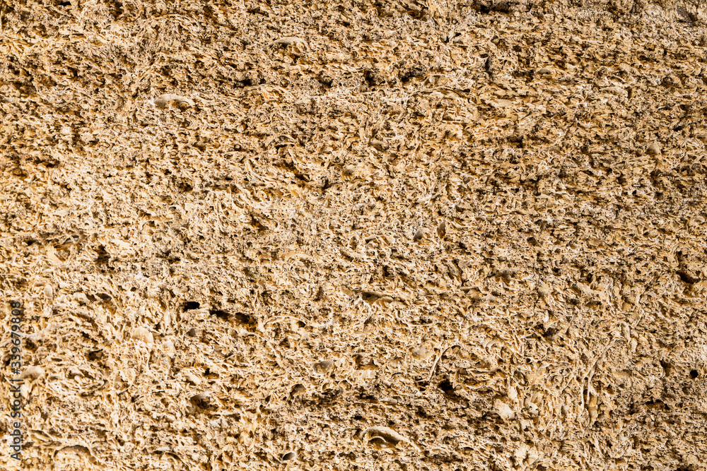 The texture of natural stone with a brown tint background for projects The texture of natural stone with a brown tint background for projects