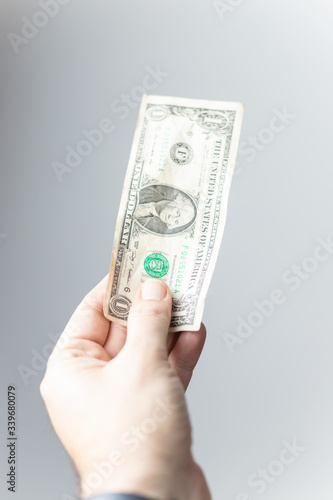 hand offering a US dollar bill