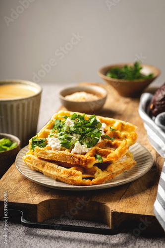 Belgian waffles with cheese and herbs, coffee, tasty breakfast, copy space