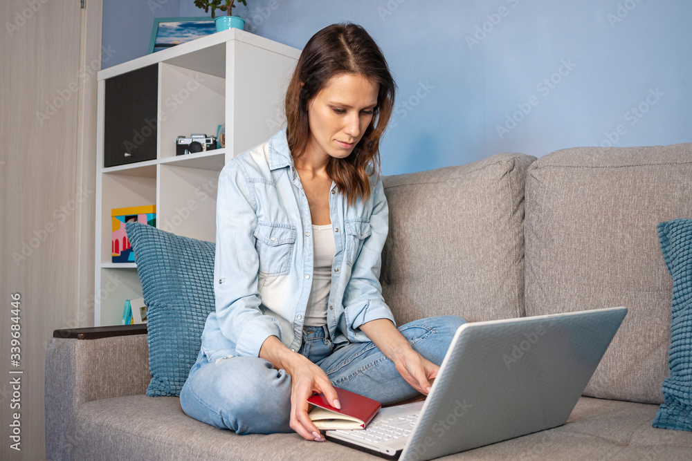Nice beautiful woman work at the notebook sit down on the sofa at home. Nice beautiful woman work at the notebook sit down on the sofa at home.
