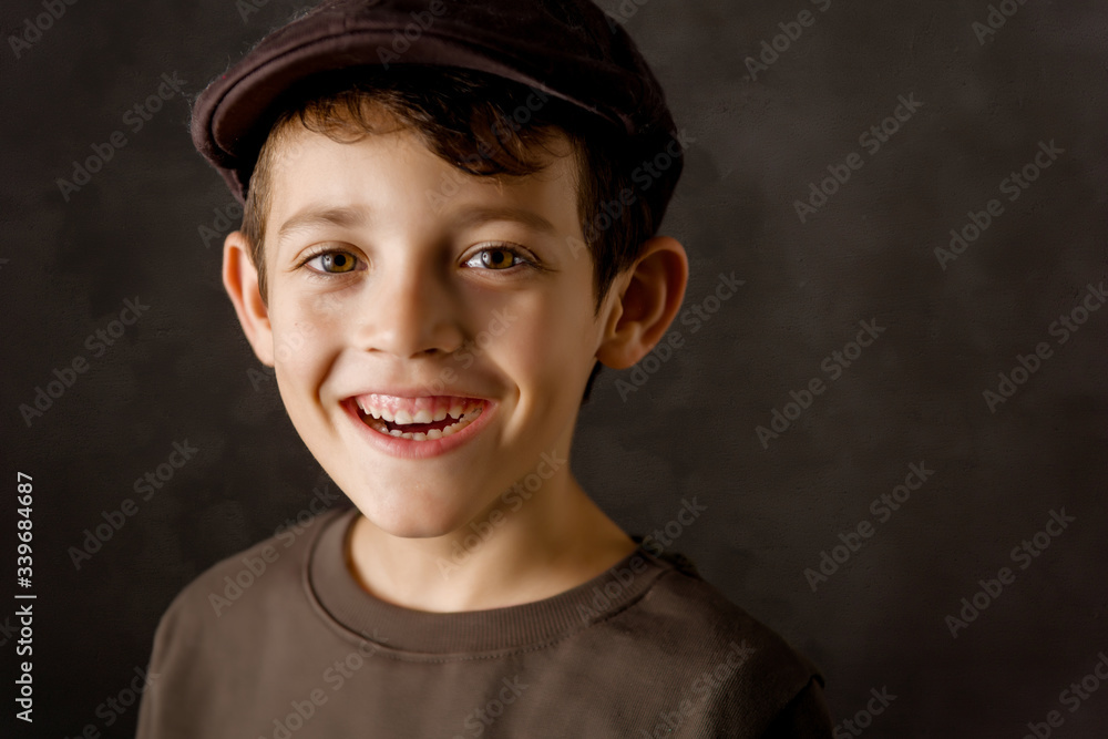 smiling kid looking at camera with a brown vintage cap smiling kid looking at camera with a brown vintage cap