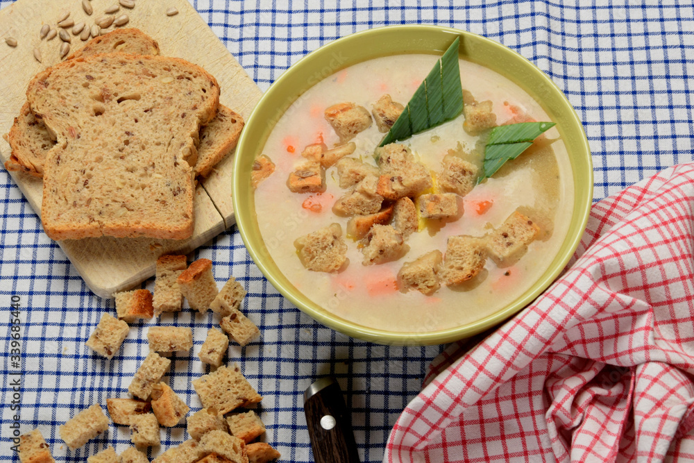 pieces of bread in a vegetable soup with sausage and bacon pieces of bread in a vegetable soup with sausage and bacon