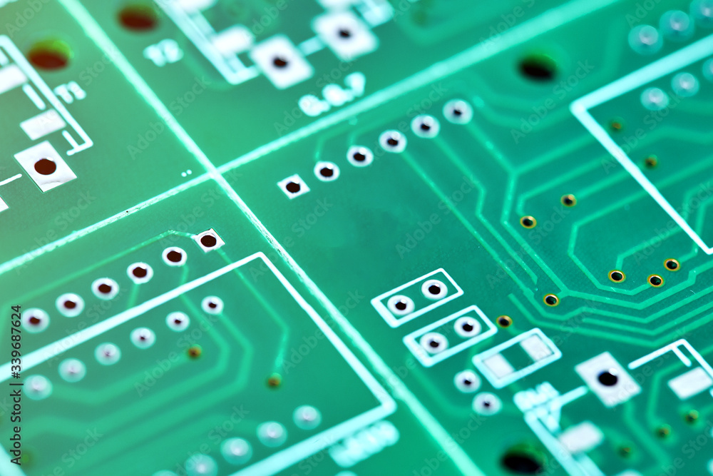 Green system board with microchips and transistors. Microchip