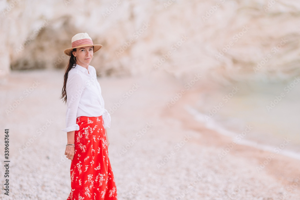 Obraz premium Woman laying on the beach enjoying summer holidays looking at the sea