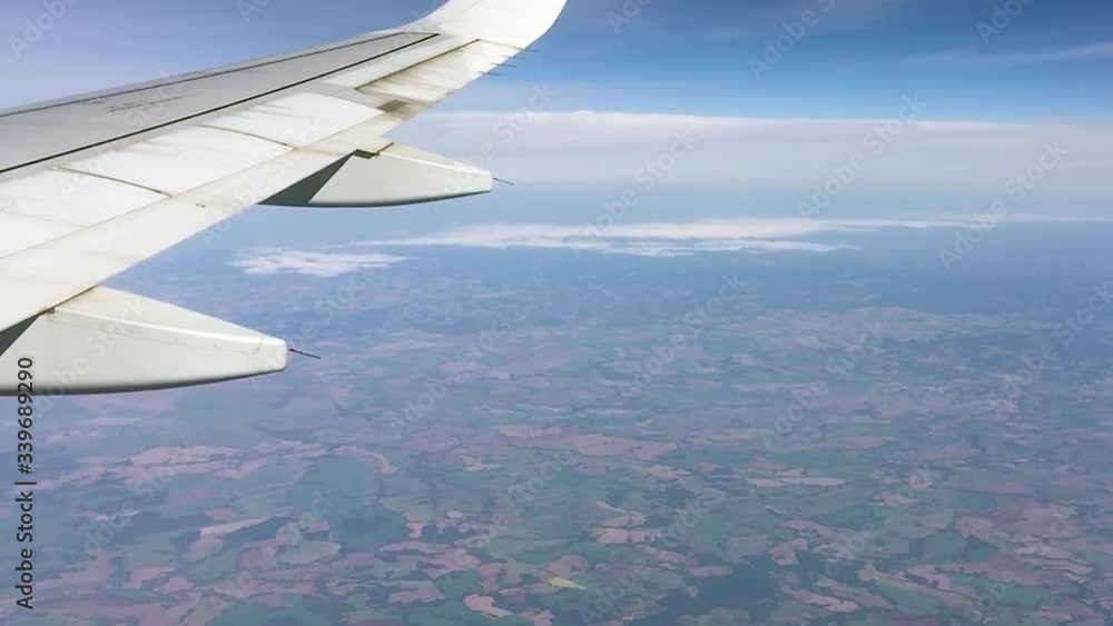 Video of an airplane flying high in the blue sky. The wing is shaking in some parts due to turbulence. Video of an airplane flying high in the blue sky. The wing is shaking in some parts due to turbulence.