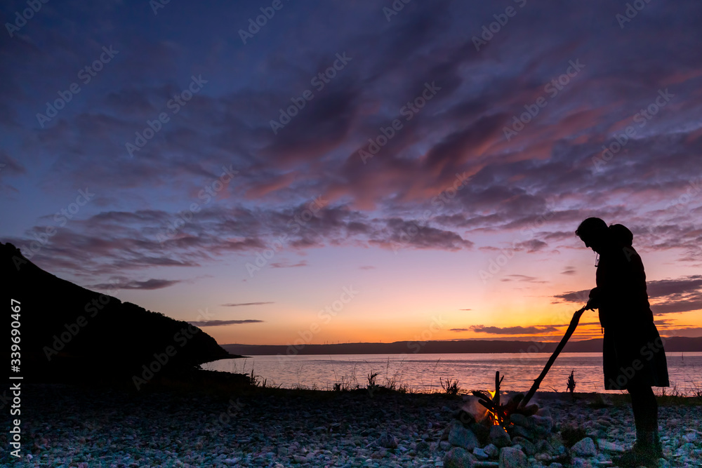 woman tending fire on Arran
