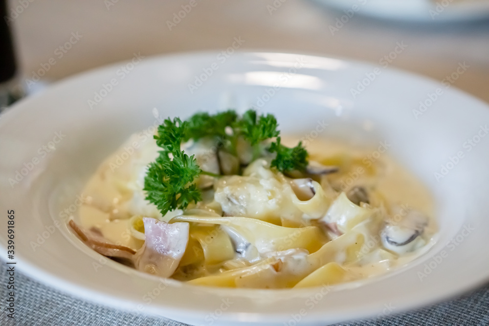 Angle view of fettuccine carbonara ham cheese. Angle view of fettuccine carbonara ham cheese.