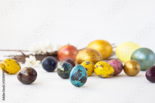 On a white background are painted eggs. Real hand-painted eggs. A multi-faceted photo. Holiday and joy of Bright Easter for the whole family