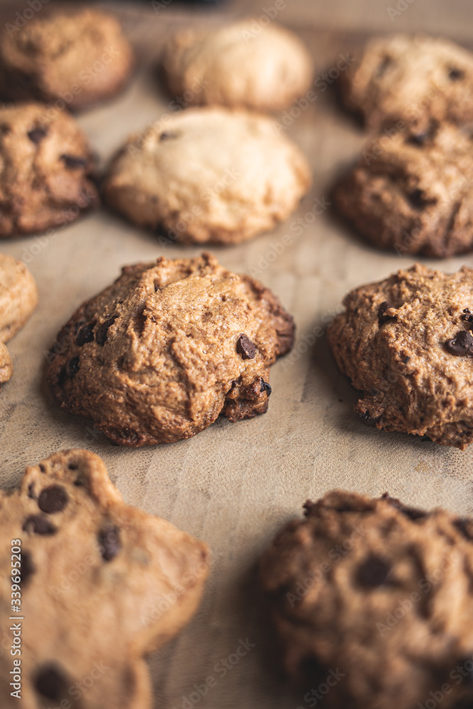 Homemade artisan chocolate cookies in a row on a wooden board Homemade artisan chocolate cookies in a row on a wooden board