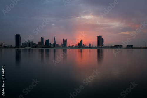 Bahrain skyline at sunset with reddish overcast sky  HDR