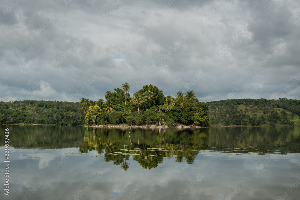 Island reflection on a lake in Guatemala during a cloudy day