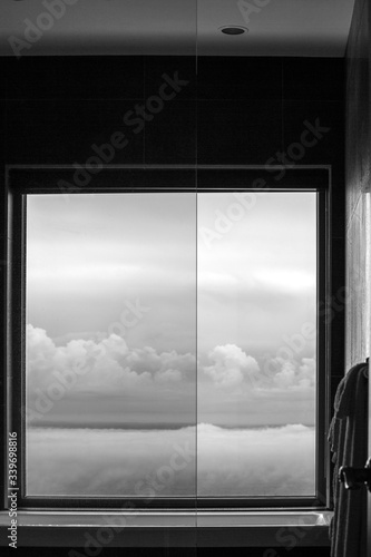 Bathroom window with a view on the clouds