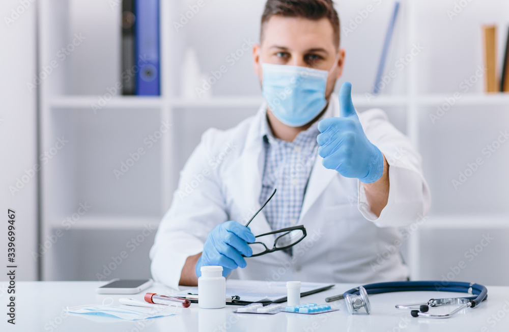Happy man doctor in cabinet with good finger sign Happy man doctor in cabinet with good finger sign