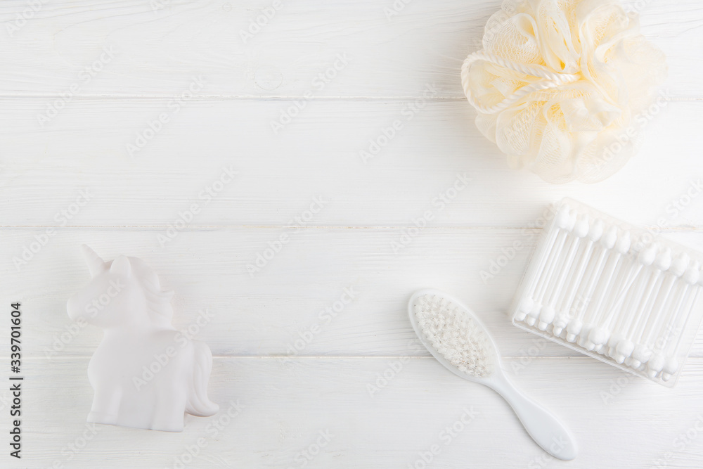 Spa and bath concept. Baby bath set. Washcloth, hair brush, ear sticks and rubber unicorn on a white background. Spa and bath concept. Baby bath set. Washcloth, hair brush, ear sticks and rubber unicorn on a white background.