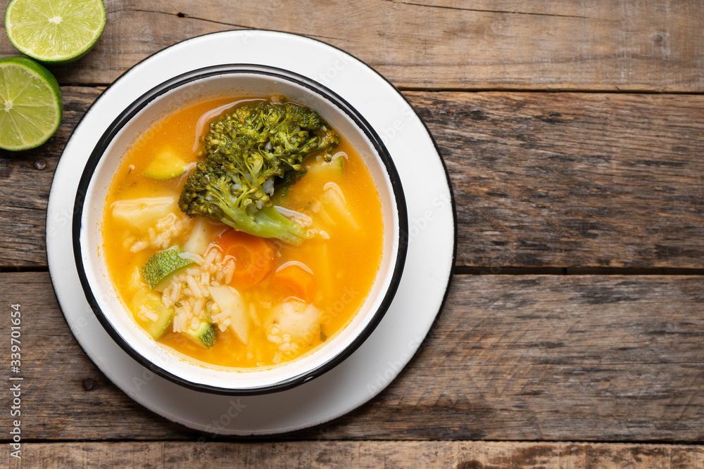 Vegetables soup with rice on wooden background Vegetables soup with rice on wooden background