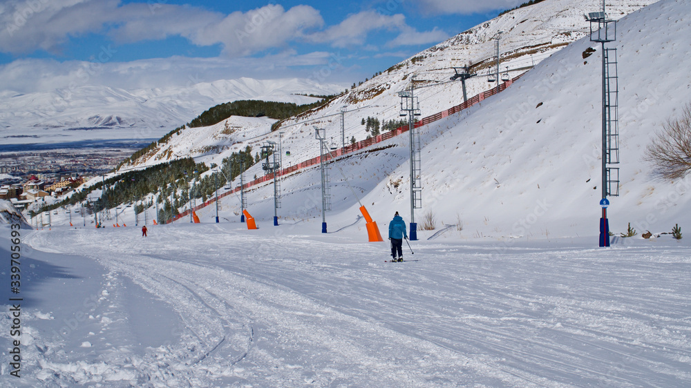 ERZURUM, TURKEY - FEBRUARY 28, 2020: Palandöken mountain ski resort. Skiing and snowboarding tourists. Young people doing ice climbing. ERZURUM, TURKEY - FEBRUARY 28, 2020: Palandöken mountain ski resort. Skiing and snowboarding tourists. Young people doing ice climbing.