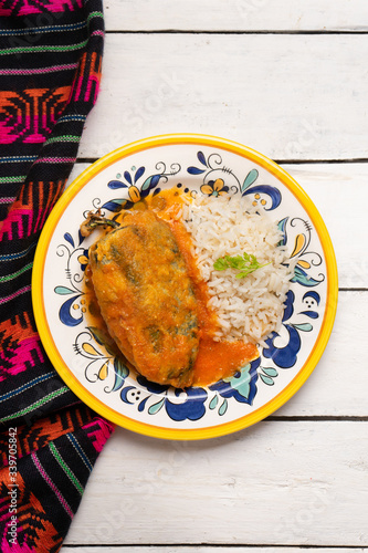 Mexican chili-stuffed poblano with rice on white background