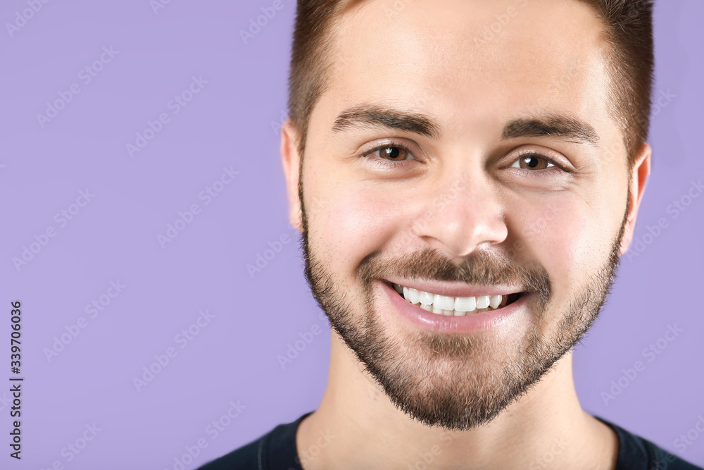 Handsome smiling young man on color background Handsome smiling young man on color background