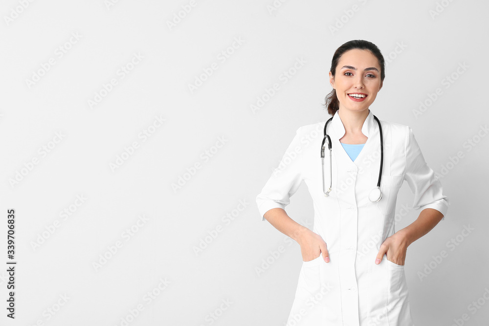 Portrait of young female doctor on light background Portrait of young female doctor on light background