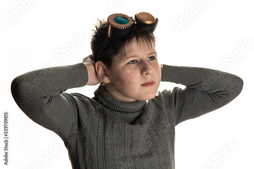 Boy in a warm sweater and steampunk glasses isolated on a white background