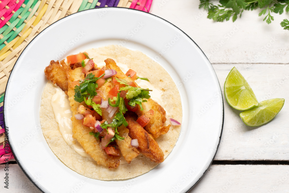 Mexican breaded fish tacos also called ensenada on white background