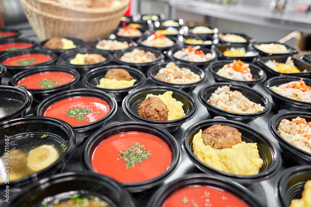 Food delivery. Different in plastic disposable lunch box with healthy natural food. Chicken broth, mashed soup, mashed potatoes with cutlet, seafood pasta, salads, pilaf with a fresh bun. Food delivery. Different in plastic disposable lunch box with healthy natural food. Chicken broth, mashed soup, mashed potatoes with cutlet, seafood pasta, salads, pilaf with a fresh bun.