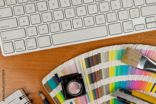 color scale with stylus and magnifying glass on it and a notebook photo