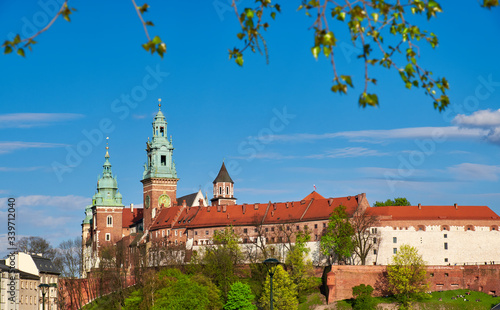Riverside of Krakow City in Poland with Wawel castle view from across the river Vistula with people, tourists, enjoying fine Spring sunny weather