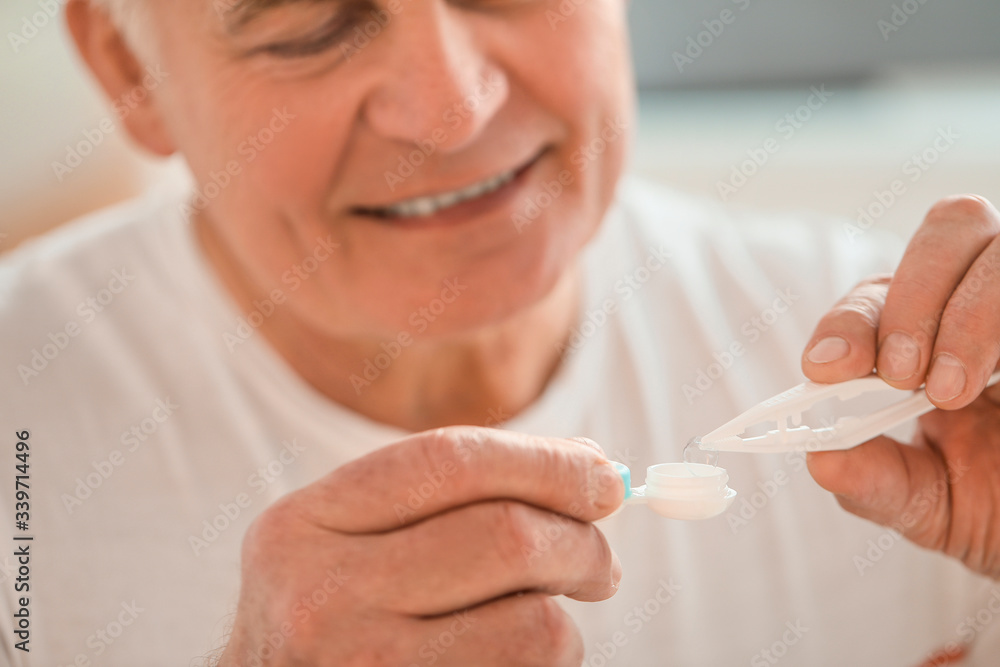 Mature man with contact lenses at home, closeup Mature man with contact lenses at home, closeup