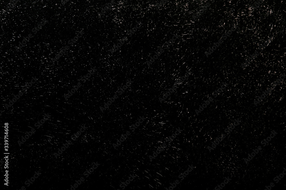 Black gray painted concrete texture or background with grain elements. High contrast and resolution image with place for text. Template for design