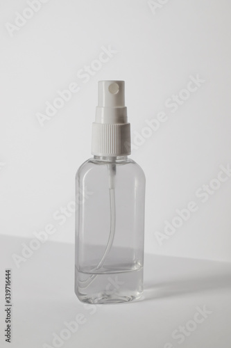 Antibacterial spray for hands close up. Virus protection alcohol disinfectant spray bottle on white background. Antibacterial spray for hands, antiseptic isolated. Vertical photo
