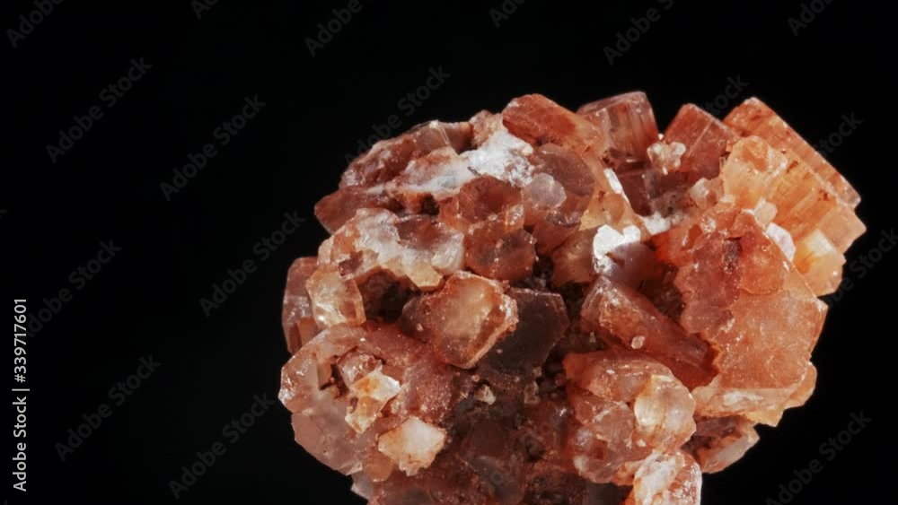 Seamlessly rotating a blood orange mineral Aragonite in front of black background Seamlessly rotating a blood orange mineral Aragonite in front of black background