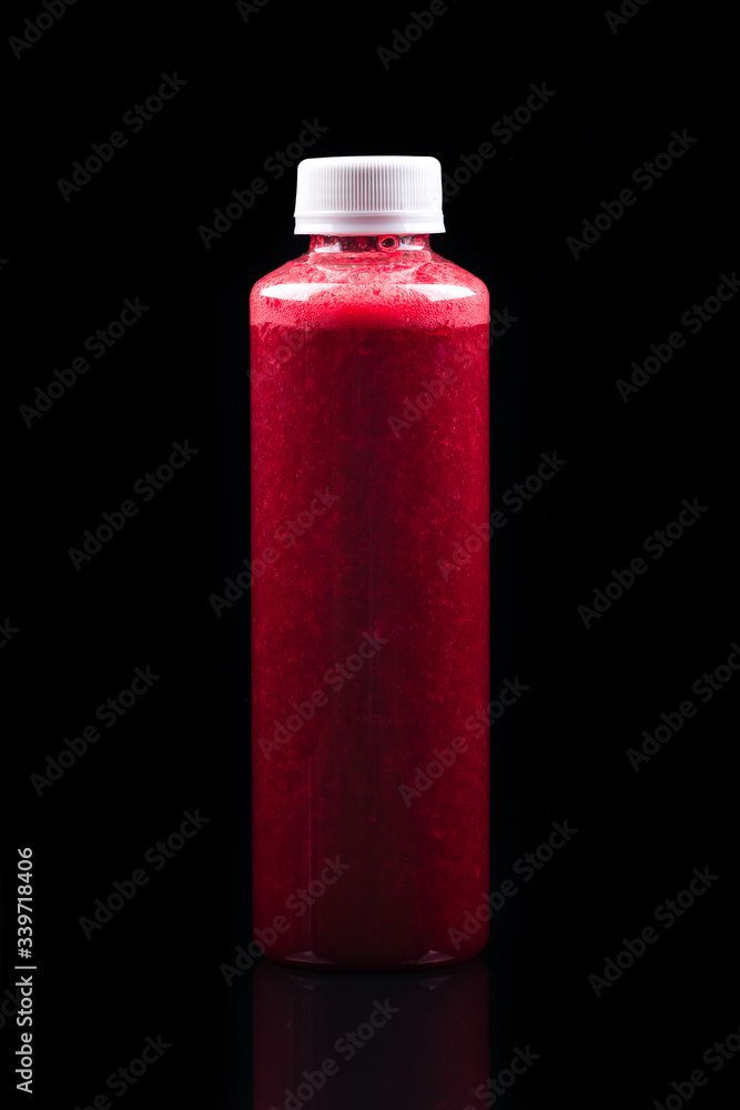 red smoothie in a bottle, take-away concept on black background red smoothie in a bottle, take-away concept on black background