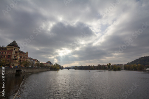 Panorama of Prague, Czech Republic, seen from the Vltava river, also called Moldau, with Most Legii, or Legion Most, one of the landmarks of the city in background, during a cloudy sunset in autumn