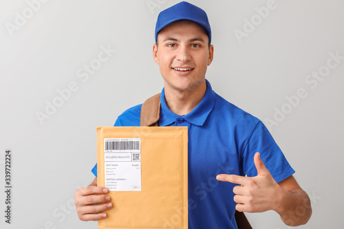 Postman with letters on light background photo