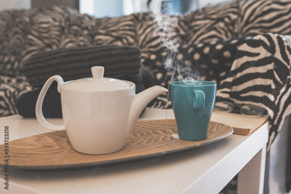 teapot and tea cup on a coffee table