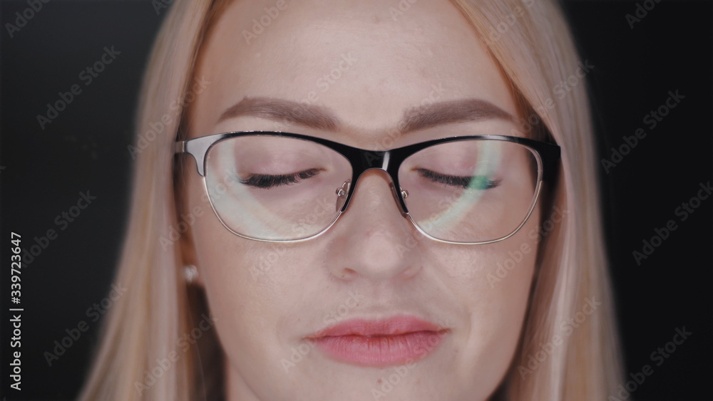 close up portrait of a beautiful young blonde hair business woman with glasses who standing with closed eyes and then open them and confidently looks in camera. Slow motion front view video in 4K. close up portrait of a beautiful young blonde hair business woman with glasses who standing with closed eyes and then open them and confidently looks in camera. Slow motion front view video in 4K.