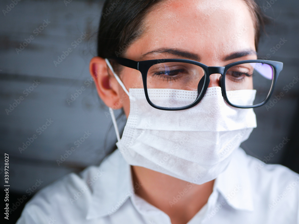 The girl works in the DNA laboratory. A young female technician or scientist works in a laboratory. Close-up