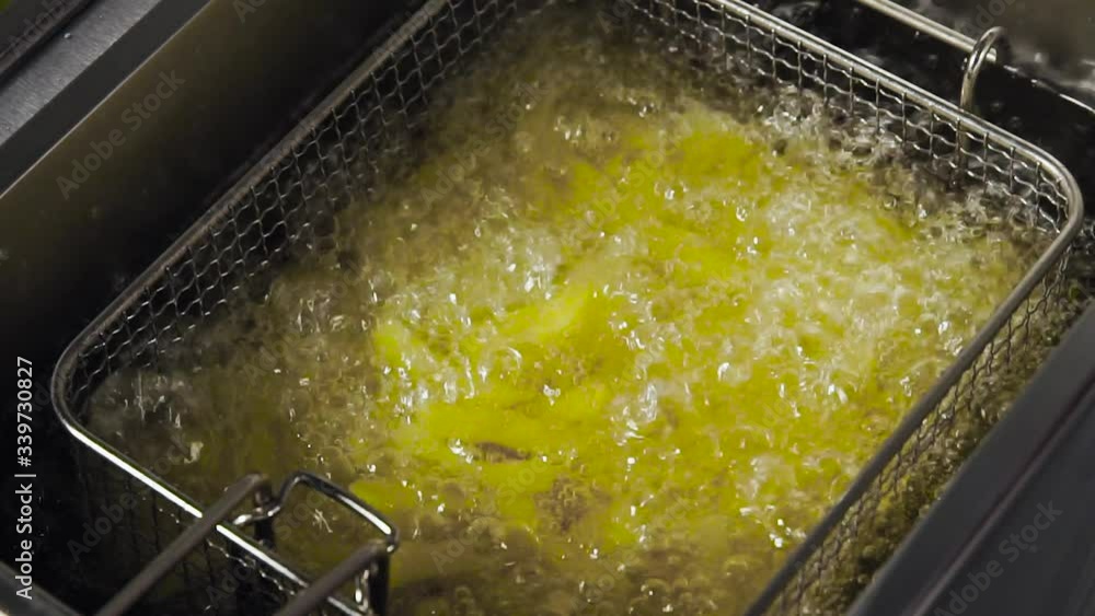 Process of cooking French fries in the deep fryer Process of cooking French fries in the deep fryer