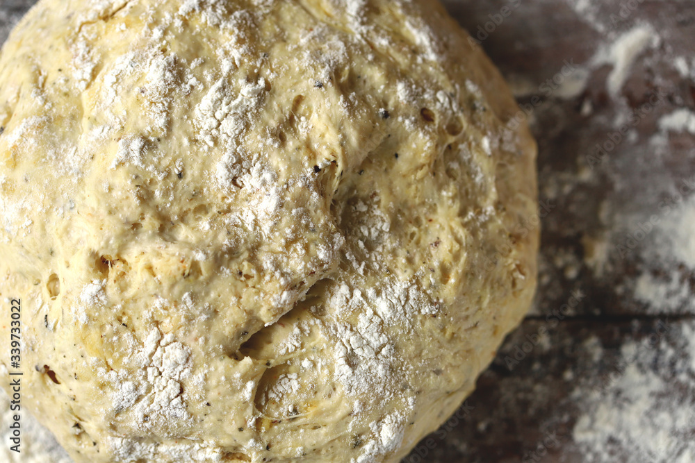 Selective focus. Macro. Fresh homemade yeast dough, olives and spices for making focaccia with Italian herbs. Cooking at home. Traditional italian bread. Selective focus. Macro. Fresh homemade yeast dough, olives and spices for making focaccia with Italian herbs. Cooking at home. Traditional italian bread.