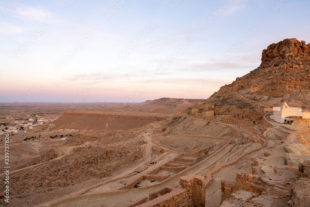 Naklejka premium red rocks in the desert old town germassa