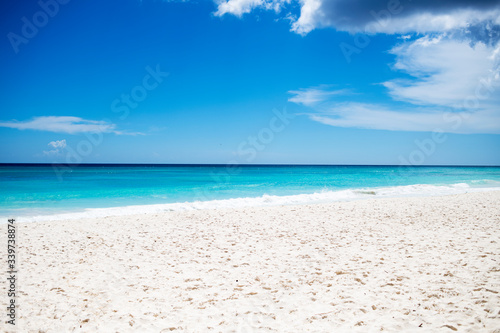 white sand beach with blue sky