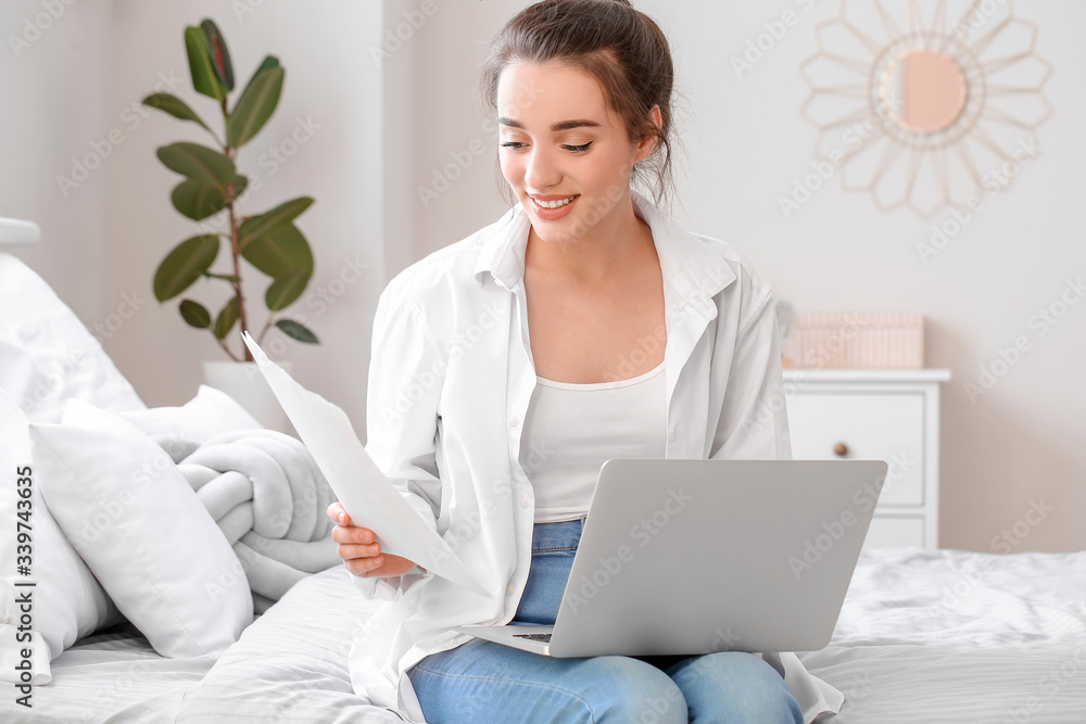 Beautiful young woman working on laptop at home Beautiful young woman working on laptop at home